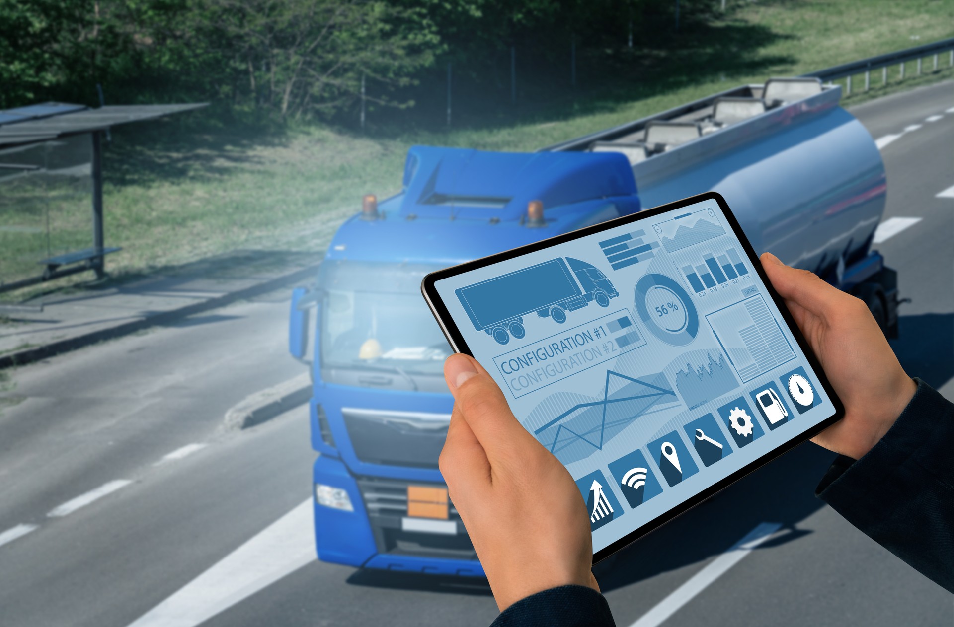 Manager with a digital tablet on the background of truck. Fleet management	.